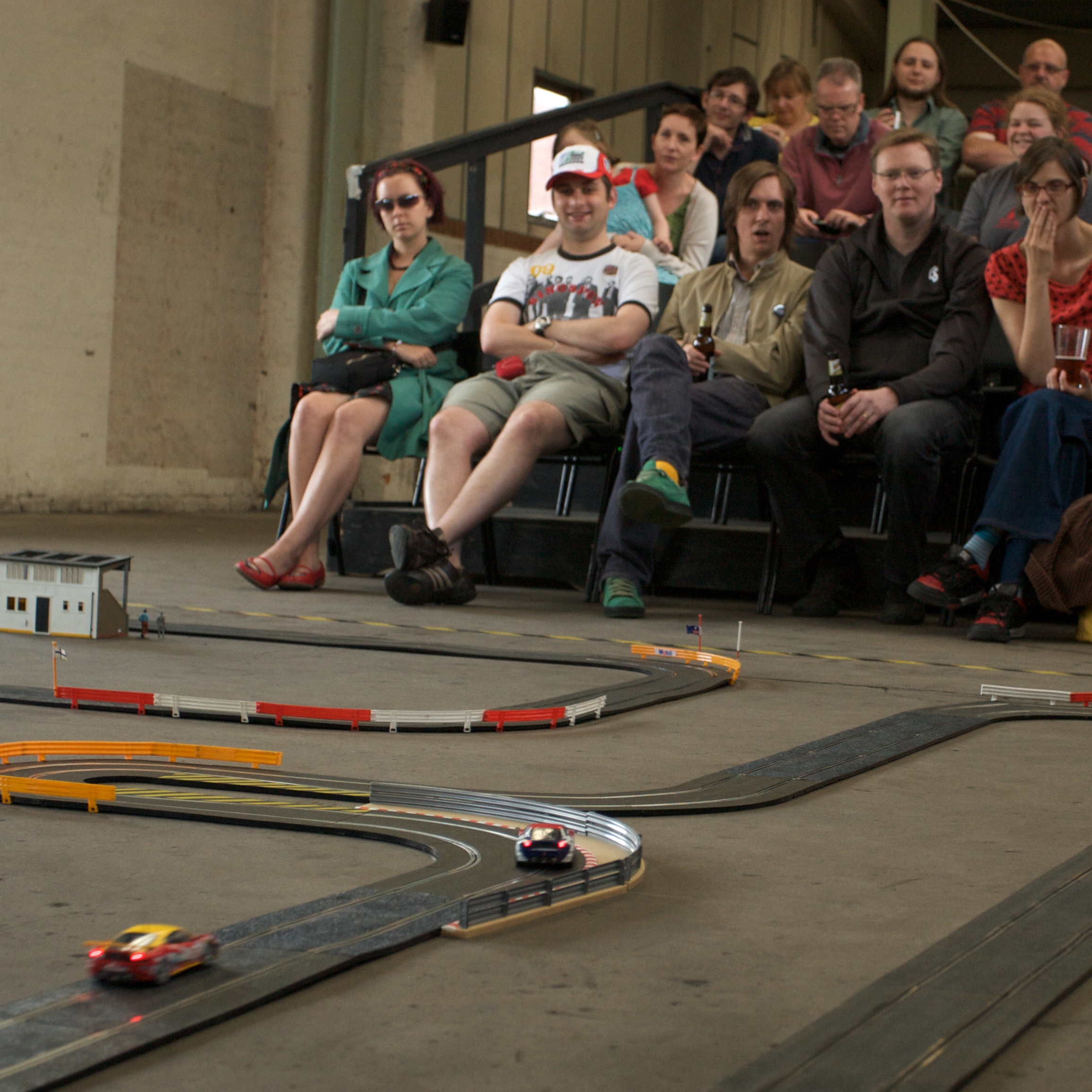 A crowd in stand watch scalextric cars race