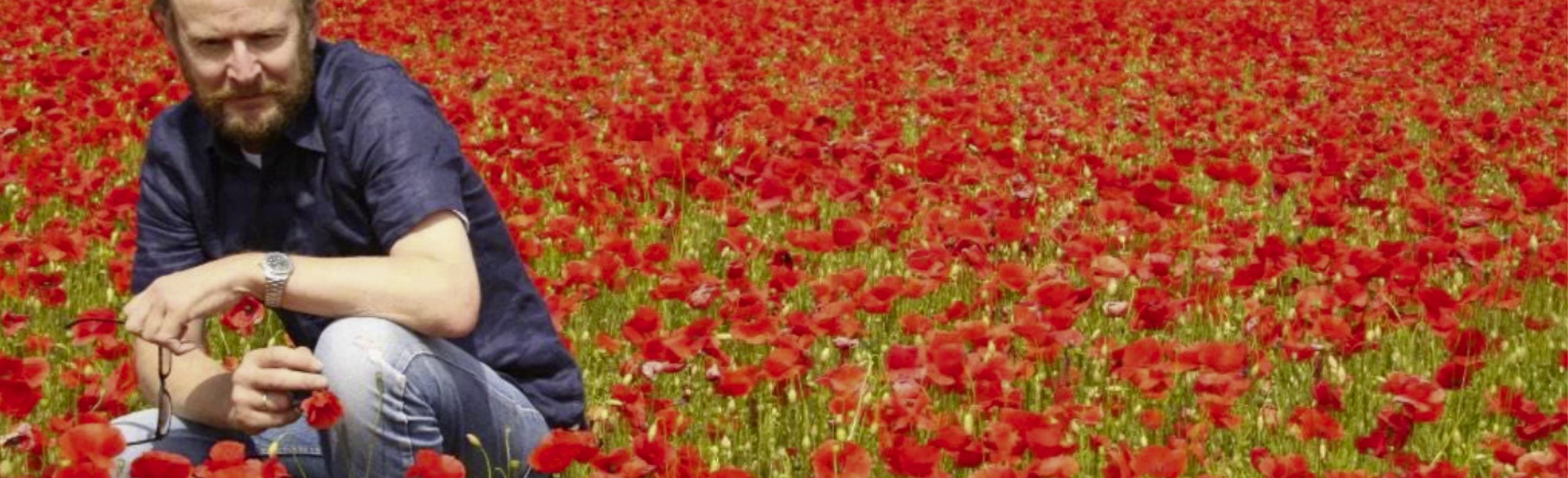 Alan James in a field of poppies
