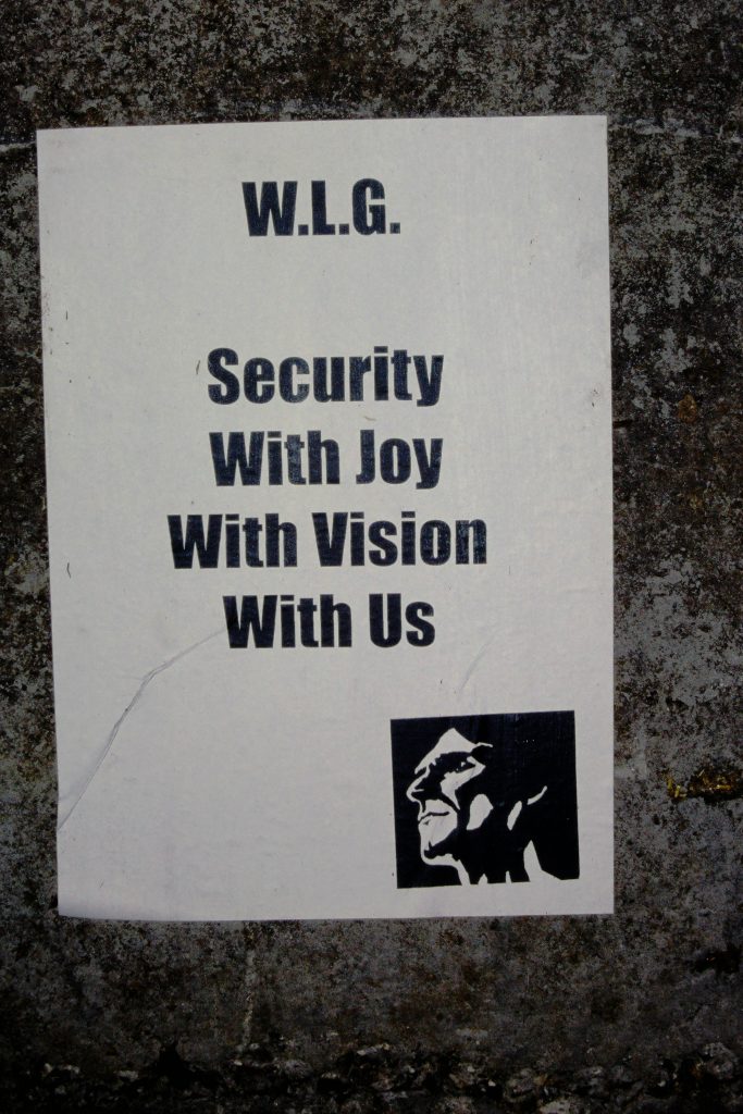 A poster saying Security, With Joy, With Vision, With Us.